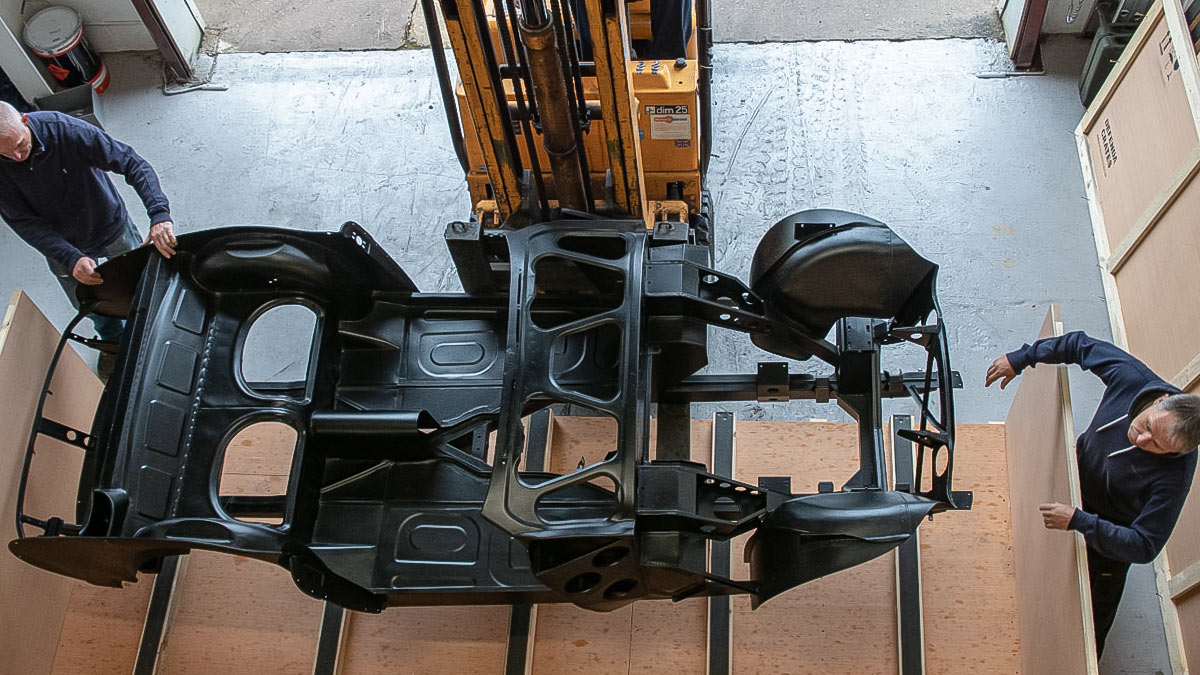 Jason Askew and Paul Askew guide the inner body assembly to its place in the crate.