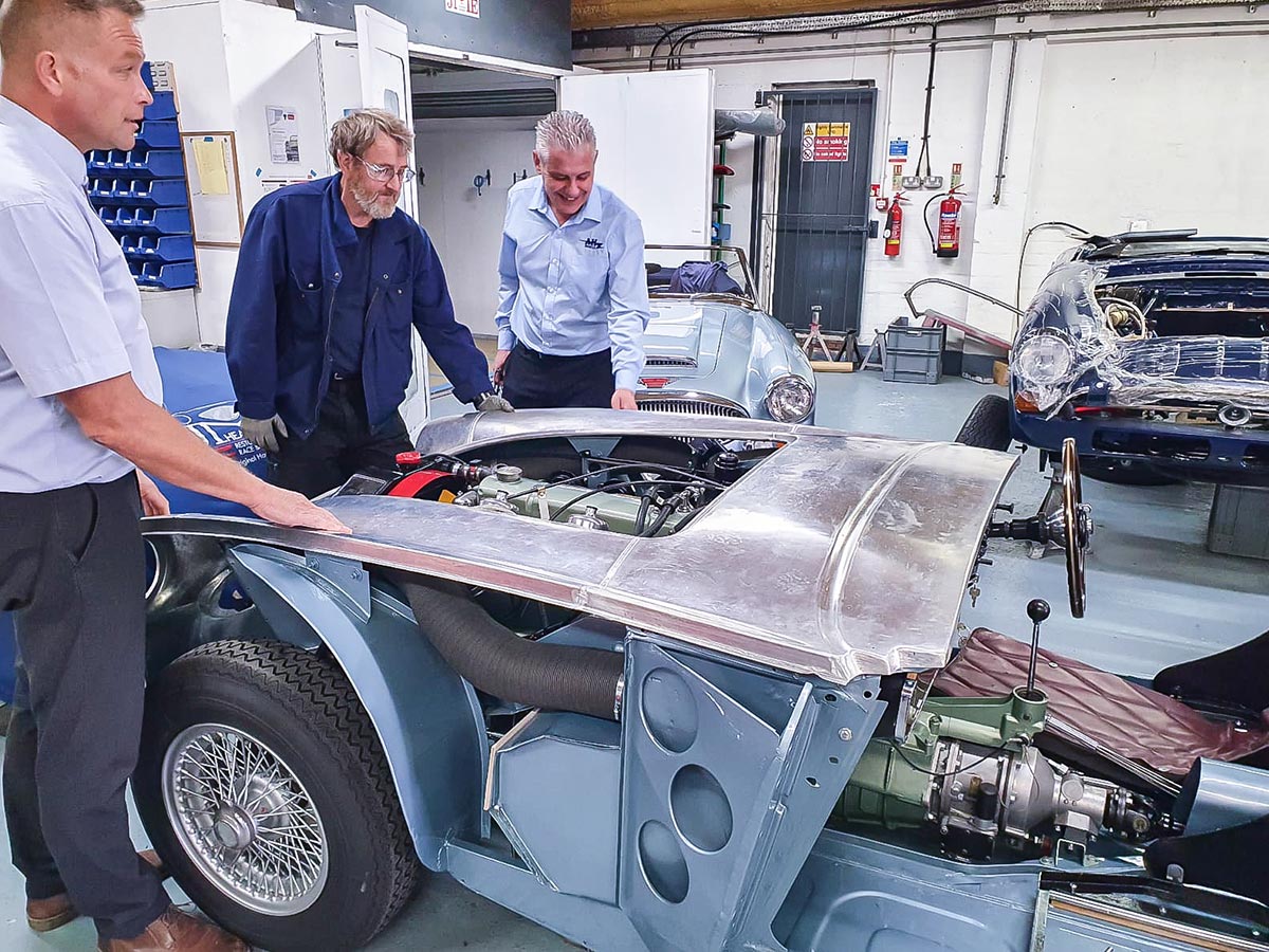 John Lee, Mark Style and Mark Friel overseeing the test fit of A H Spares new Austin Healey outer body shell at JME Healeys