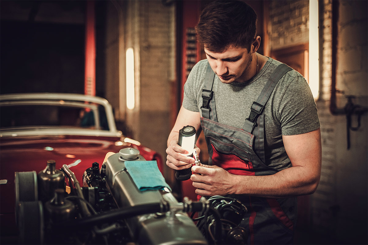 Mechanic inspecting Austin Healey engine