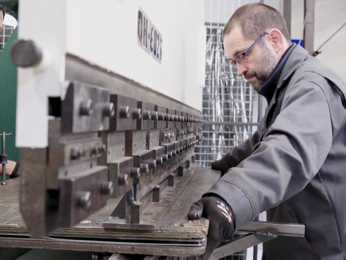 Man operating press brake at A H Panels.