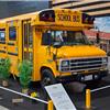 Restored yellow American school bus on display at Époqu’Auto Lyon 2025 classic c