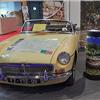 Yellow MG convertible on display at Époqu’Auto Lyon 2025 featuring a touring map