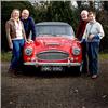 The Hill family standing with their restored red Austin Healey 3000 BJ8 HMO 991D