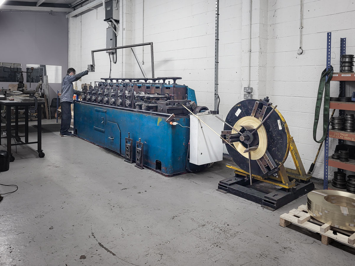 Rolling machine in action bending brass strips
