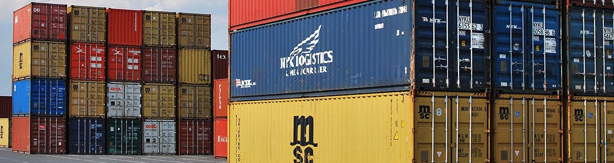 Shipping containers stacked at a port prior to customs inspection
