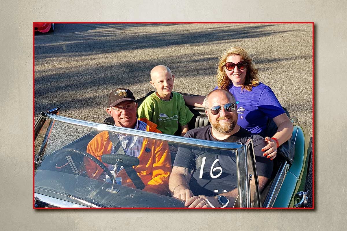 Steve Ormerod in his Austin Healey 3000 with a family