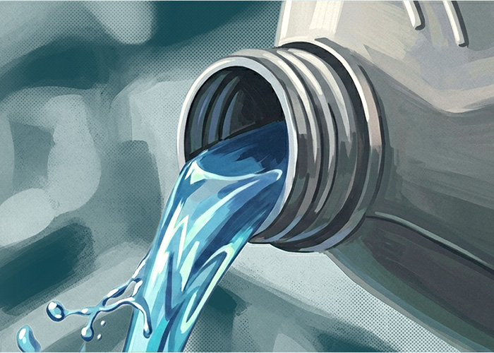 Blue engine coolant being poured from a bottle
