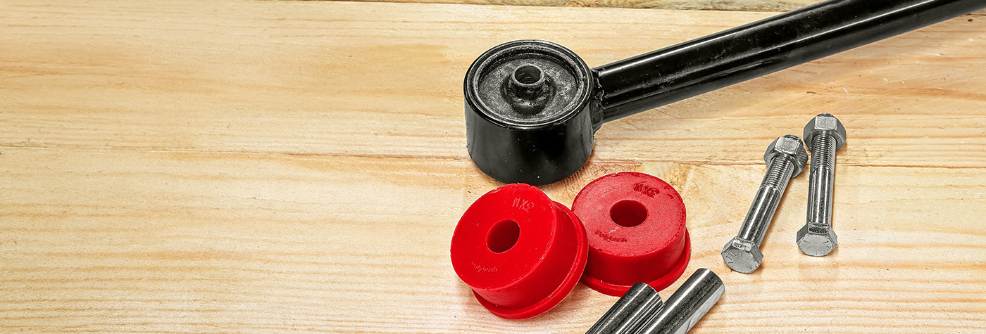 BJ8 radius arm with a pair of red performance Polybush bushes, centre pins and bolts