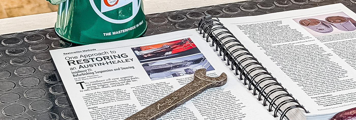 Roger Moment's Austin Healey guide open beside workshop tools