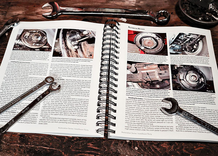 Roger Moment's Austin Healey guide open on a workshop bench