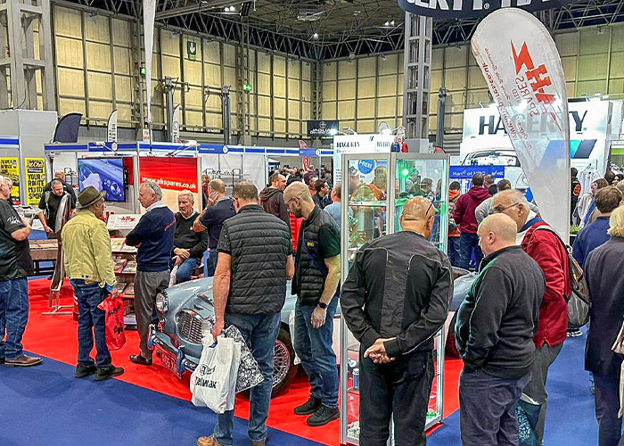 A H Spares team member Brian talking with visitors about Austin Healey parts and restoration at the 2025 NEC Classic Motor Show.