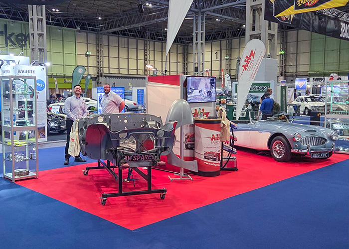 A H Spares stand at the 2025 Classic Motor Show Birmingham displaying Austin Healey chassis and panels with team members Ryan and Matt.