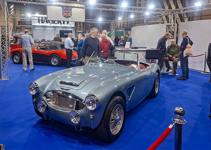 Austin Healey 3000 display by the Austin Healey Club at the NEC Classic Motor Show 2025 with enthusiasts admiring the cars.