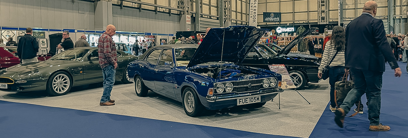 Classic cars on display at the 2025 NEC Classic Motor Show in Birmingham, including restored saloons, coupes and sports cars.