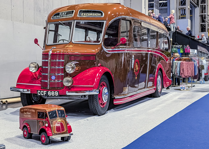 Restored Ray Herrit & Sons vintage excursion bus on display at the 2025 NEC Classic Motor Show in Birmingham.
