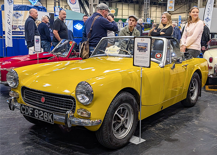 Bright yellow MG Midget displayed by the Midget and Sprite Club Young Members at the 2025 Classic Motor Show Birmingham.