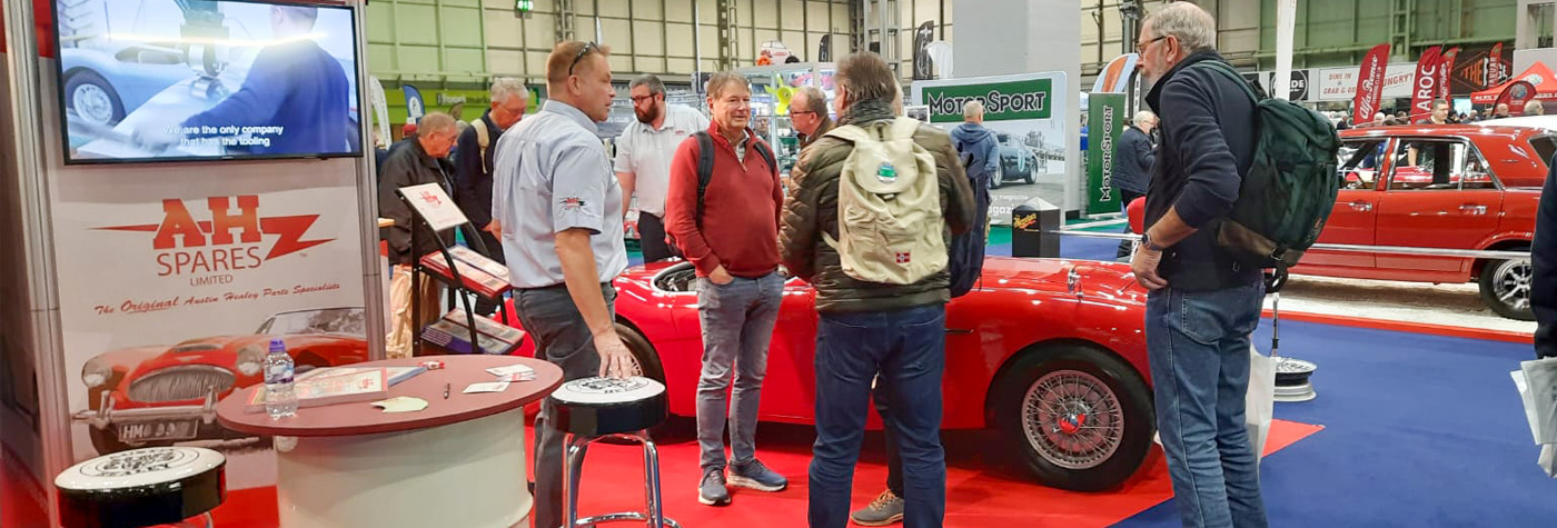 A H Spares stand at the NEC Classic Motor Show with Austin Healey display car and visitors