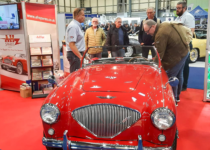 A H Spares showcasing red Austin Healey 100 BN1 to enthusiasts at Classic Motor Show 2025