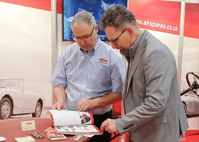 Parts Manager, Paul Askew, discussing Austin Healey parts at Techno Classica Essen
