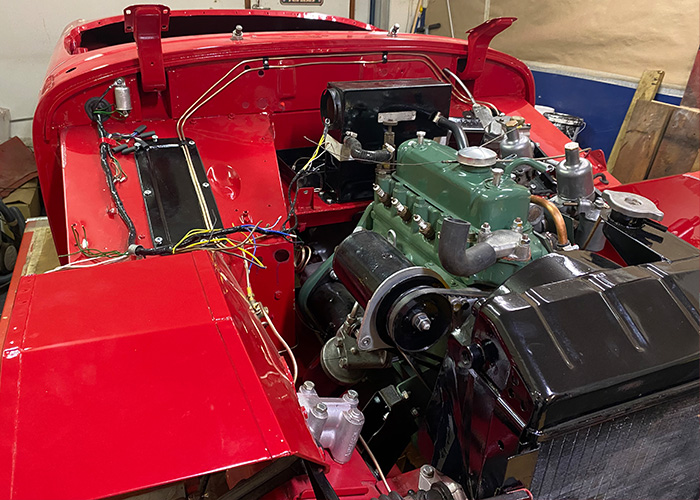 Austin Healey Frogeye Sprite restoration progress with rebuilt A-Series engine fitted into the painted bodyshell.