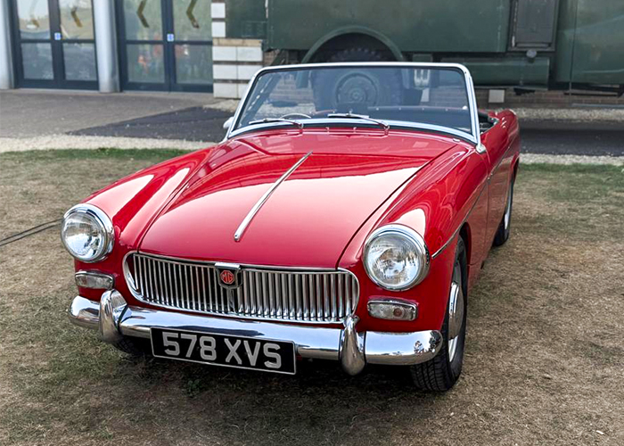 1960s-era MG Midget sports car in red at the British Motor Museum’s Gaydon Gathering.