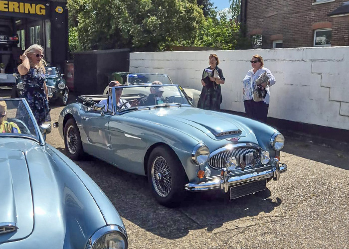 Blue Austin Healey 3000 getting ready to leave