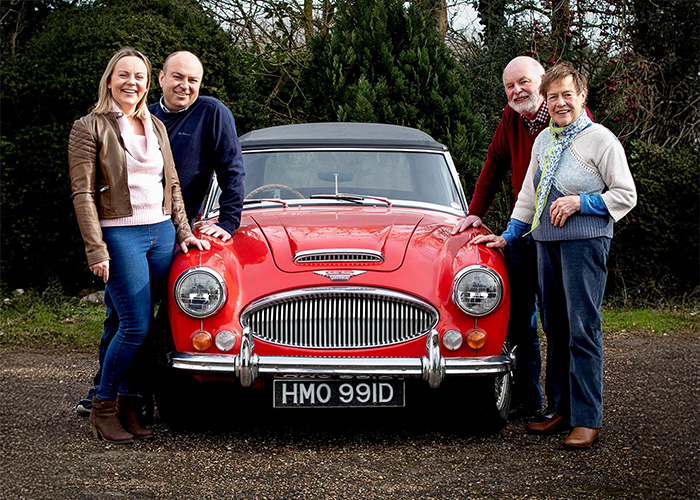 The Hill family standing with their red Austin Healey 3000 BJ8 HMO 991D