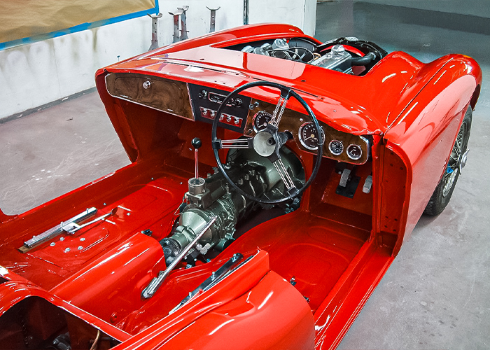 Painted Austin-Healey BJ8 interior with exposed gearbox and seat runners during build-up at JME Healeys