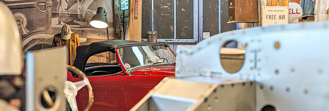Austin Healey BN1 positioned behind a BT7 inner bodyshell assembly in the A H Spares workshop