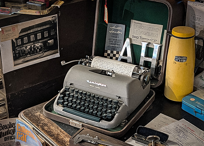 Period office typewriter with A H Spares letterhead displayed in showroom