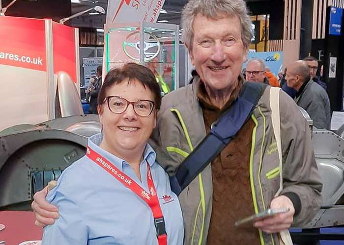 Patricia from A H Spares with an Austin Healey owner beside the BT7 inner bodyshell assembly at Rétromobile 2026.