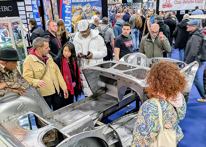 Visitors examining the Austin Healey BT7 inner bodyshell assembly at the A H Spares stand during Rétromobile 2026.