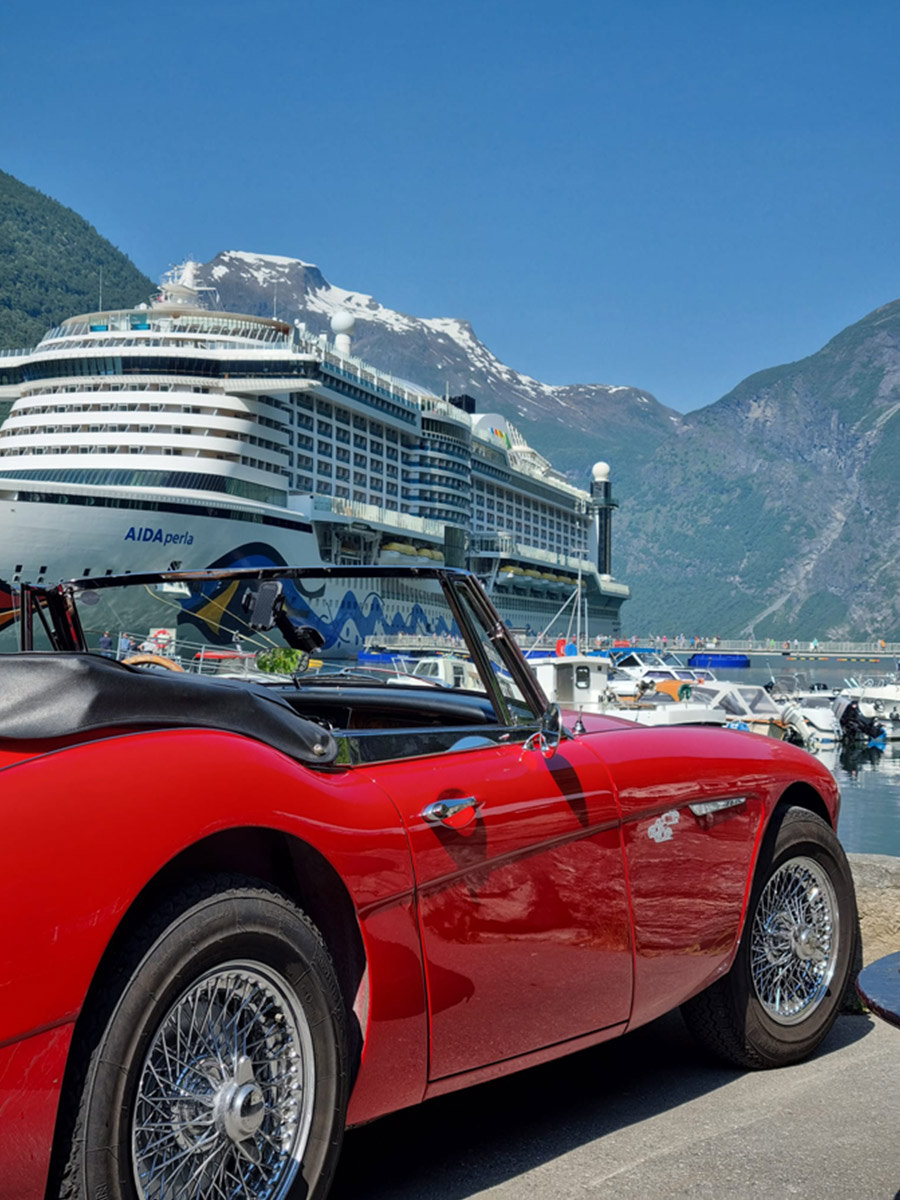 Red Austin Healey 3000 with a ferry background