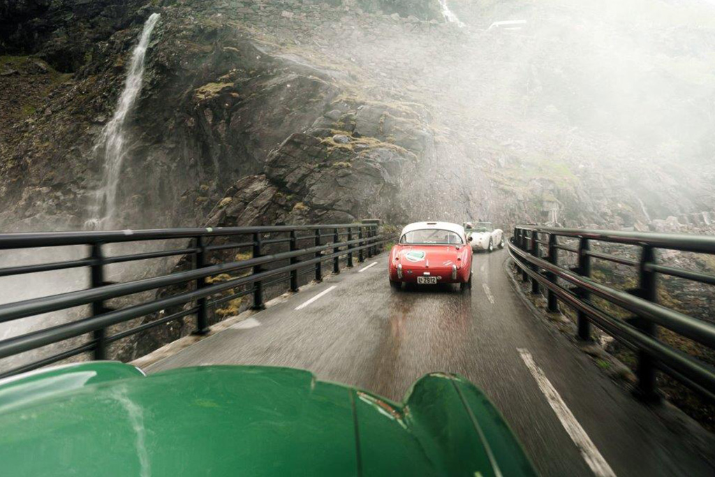 Austin Healeys driving over a bridge in the mountains in Norway