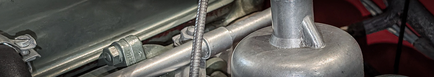 Close-up of Austin Healey 100M carburettor assembly and linkages, showing precision detailing of H6 components for Le Mans specification engines