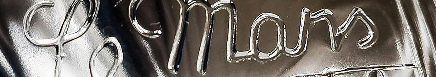 Engraved detail of Austin Healey 100M Le Mans Lucas headlamp unit, symbolising the distinctive lighting and race specification of the 100M model.