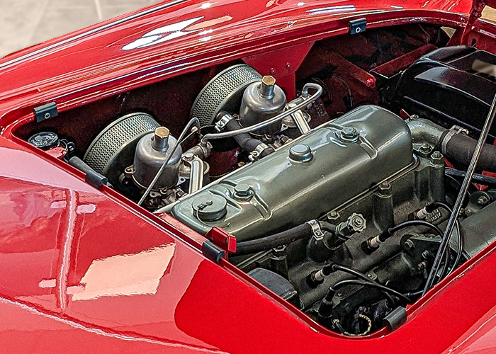 Austin Healey 100 BN1 engine bay with twin SU carburettors and restored Burgess air filters fitted with plaques.