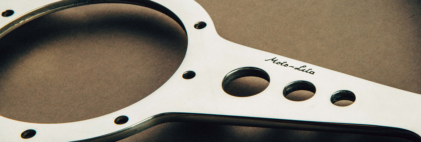 Close-up of the Moto-Lita name engraved on an Austin Healey steering wheel
