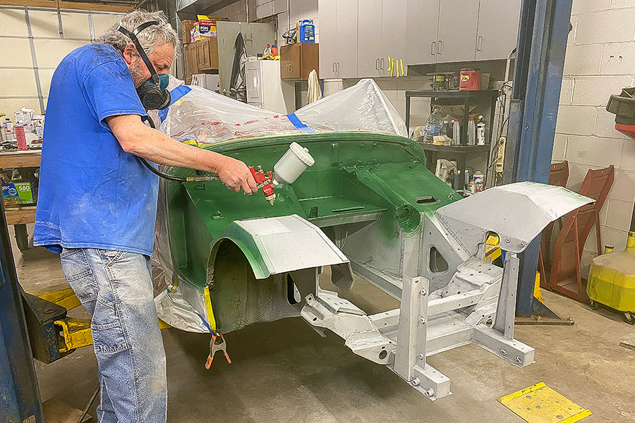 Engine bay of Cari Kalapis' Austin Healey Sprite being painted British Racing Green in May 2022