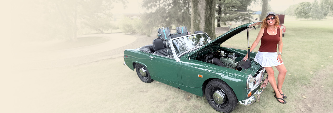 Cari Kalapis beside her restored British Racing Green 1969 Austin Healey Sprite MkIV