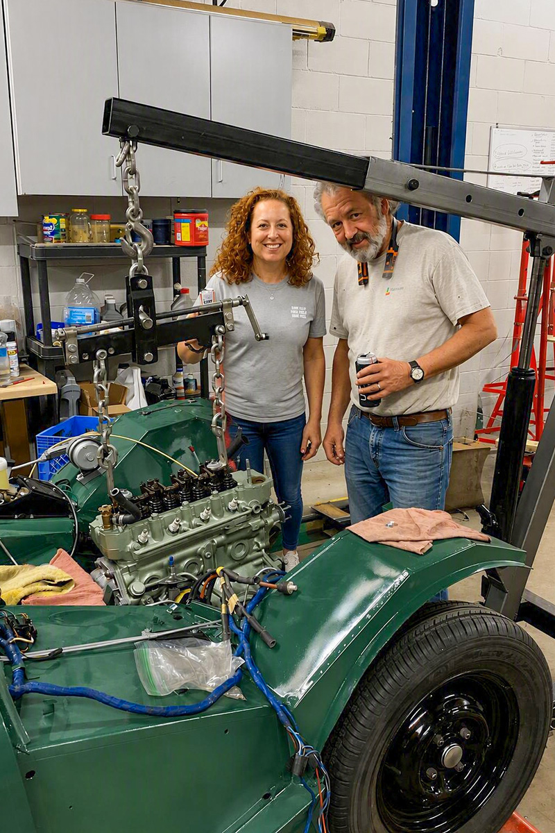 Cari Kalapis and Matt Long beside the Austin Healey Sprite as its engine was installed in July 2022