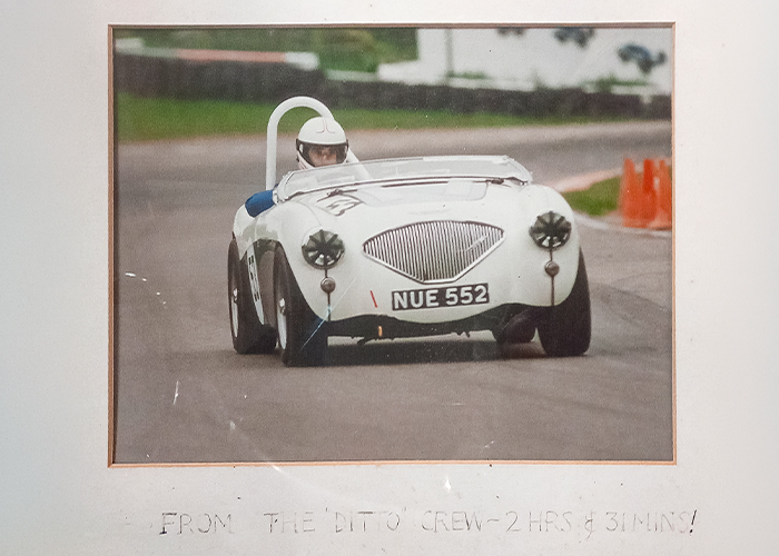 Framed photograph of Graham Foster racing NUE 552, inscribed from the Ditto crew after DTW was stripped for repair
