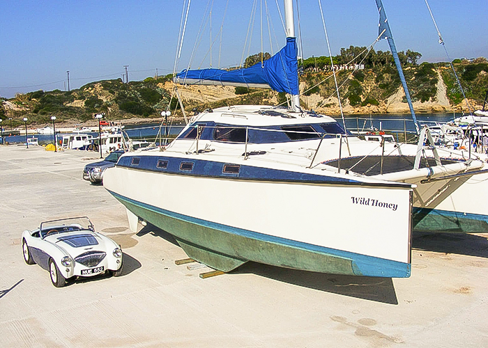 Graham Foster's Austin Healey 100/4 beside his sailing boat in Greece