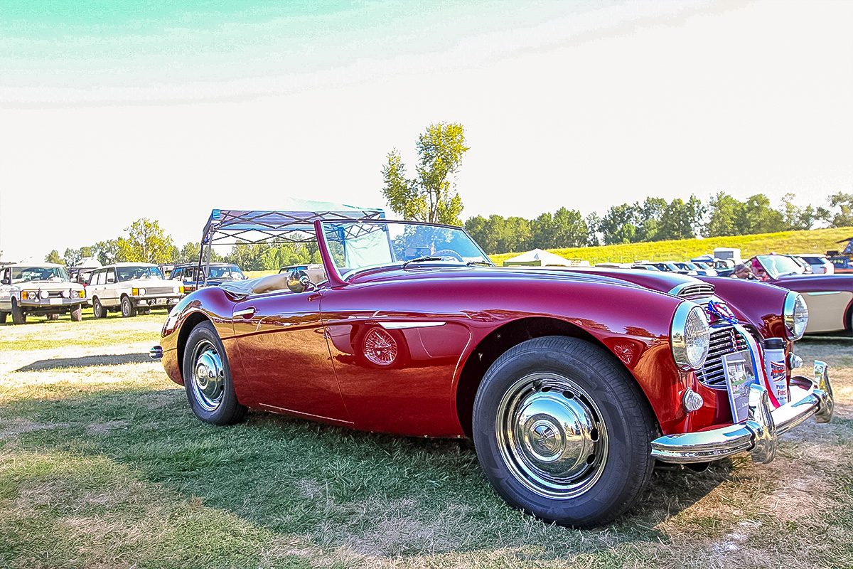 Restored dark red 1961 Austin Healey 3000 displayed at a car show