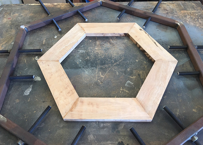 Sections of ribbon maple arranged in a jig to form the Austin Healey steering-wheel rim