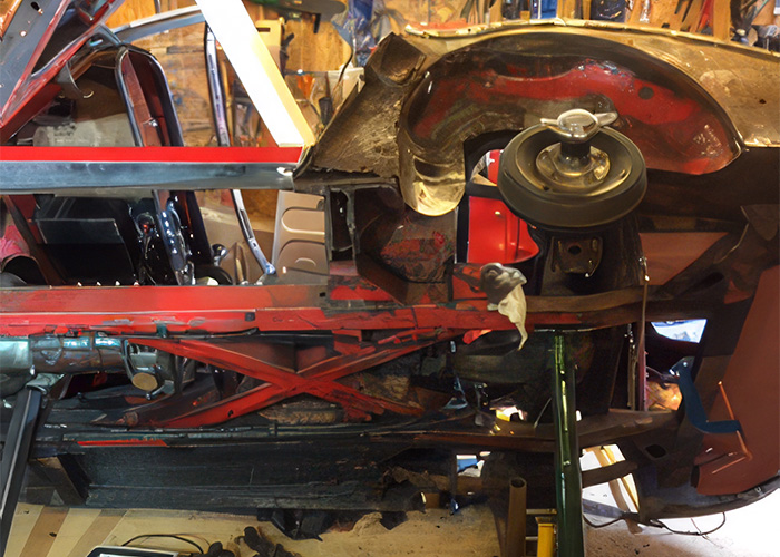 Corroded underside and structural rust on Peter Hunt's 1965 Austin Healey 3000 during inspection