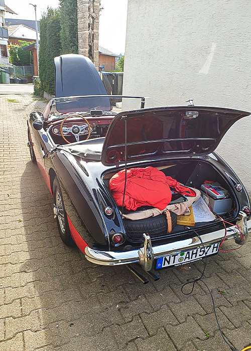 Rear three-quarter view of restored Austin Healey 100/6 with boot open